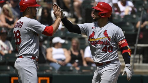 St. Louis Cardinals' Willson Contreras (40) high fives Nolan Arenado after they scored on Contreras' two run home run against the Chicago White Sox during the fourth inning of a baseball game, Sunday, July 9, 2023, in Chicago. (AP Photo/Matt Marton)