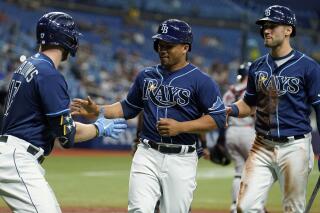 Tampa Bay Rays' Francisco Mejia, center, and Kevin Kiermaier, right, celebrate with Austin Meadows after Mejia and Kiermaier scored on an RBI single by Wander Franco off Boston Red Sox pitcher Brad Peacock during the third inning of a baseball game Tuesday, Aug. 31, 2021, in St. Petersburg, Fla. (AP Photo/Chris O'Meara)
