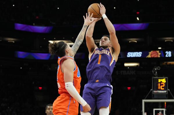 Phoenix Suns guard Devin Booker (1) shoots over Oklahoma City Thunder forward Lindy Waters III during the first half of an NBA basketball game, Wednesday, March 8, 2023, in Phoenix. (AP Photo/Rick Scuteri)