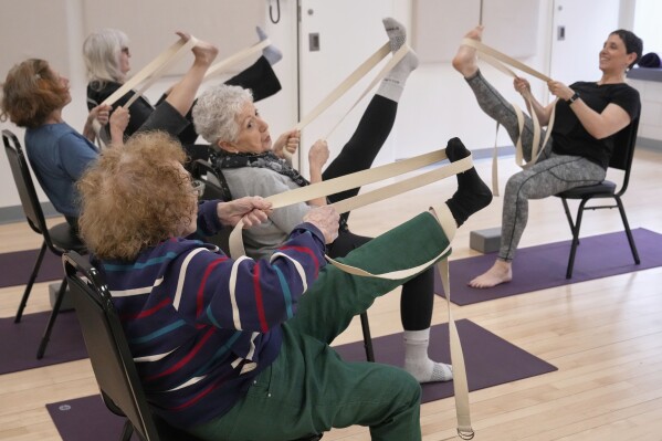 Whitney Chapman, right, conducts a chair yoga class at the Marlene Meyerson JCC Manhattan, in New York, March 28, 2025. (AP Photo/Richard Drew)