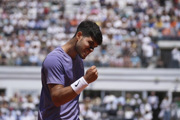 Spain's Carlos Alcaraz celebrates after a winning point during a round of sixteen match against Russia's Karen Khachanov at the Italian Open tennis tournament in Rome, Tuesday, May 13, 2025. (AP Photo/Andrew Medichini)