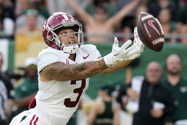 Alabama wide receiver Jermaine Burton can't catch a pass from quarterback Tyler Buchner during the first half of an NCAA college football game against South Florida Saturday, Sept. 16, 2023, in Tampa, Fla. (AP Photo/Chris O'Meara)