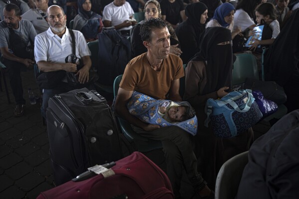 Palestinians wait to cross into Egypt at Rafah, Gaza Strip, on Wednesday, Nov. 1, 2023. (AP Photo/Fatima Shbair)