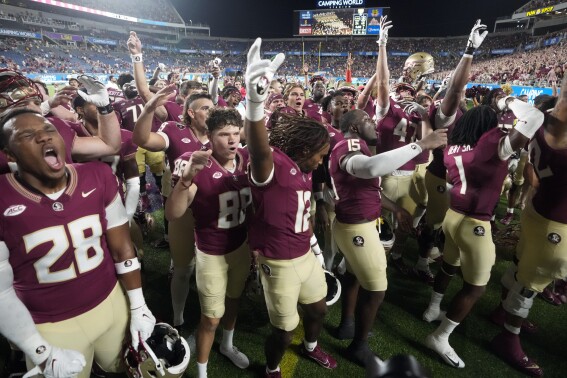 Florida State players celebrate after defeating LSU in an NCAA college football game Sunday, Sept. 3, 2023, in Orlando, Fla. (AP Photo/John Raoux)