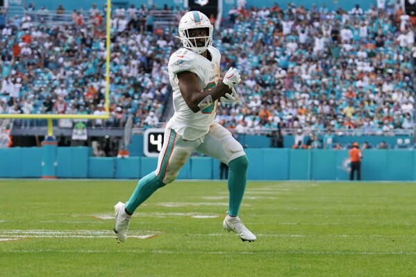 Miami Dolphins running back Raheem Mostert (31) runs for a touchdown during the first half of an NFL football game against the New York Jets, Sunday, Dec. 17, 2023, in Miami Gardens, Fla. (AP Photo/Lynne Sladky)