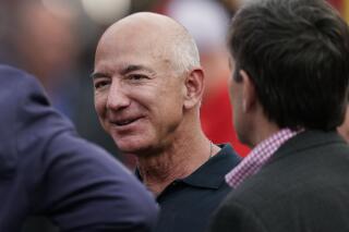Amazon founder Jeff Bezos is seen on the sidelines before the start of an NFL football game, Sept. 15, 2022, in Kansas City, Mo. Bezos said in an interview with CNN that he will give away the majority of his wealth during his lifetime. The billionaire didn’t specify how - or to whom - he will give away the money, but said he and his girlfriend, Lauren Sanchez, were building the “capacity” to do it. Bezos has been criticized in the past for not pledging to donate the majority of his wealth through philanthropy. He stepped down as Amazon CEO last year to devote more time to philanthropy and other projects. (AP Photo/Charlie Riedel)