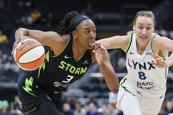 Seattle Storm forward Nneka Ogwumike drives to the basket past Minnesota Lynx forward Alanna Smith during the first quarter of a WNBA basketball game Tuesday, May 14, 2024, in Seattle. (Jennifer Buchanan/The Seattle Times via AP)
