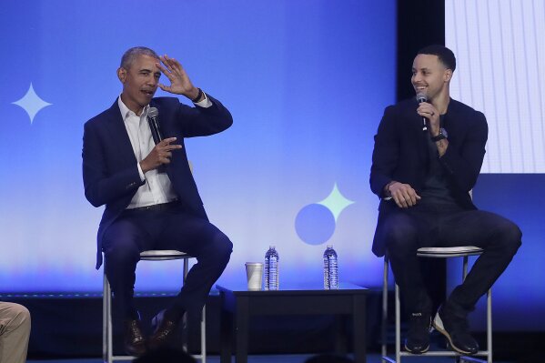 
              Former President Barack Obama, left, gestures as Golden State Warriors basketball player Stephen Curry laughs while speaking at the My Brother's Keeper Alliance Summit in Oakland, Calif., Tuesday, Feb. 19, 2019. (AP Photo/Jeff Chiu)
            