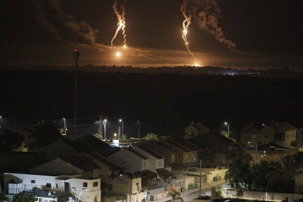 Flares rise over the Gaza Strip, as seen from southern Israel, Thursday, Nov. 16, 2023. (AP Photo/Leo Correa)