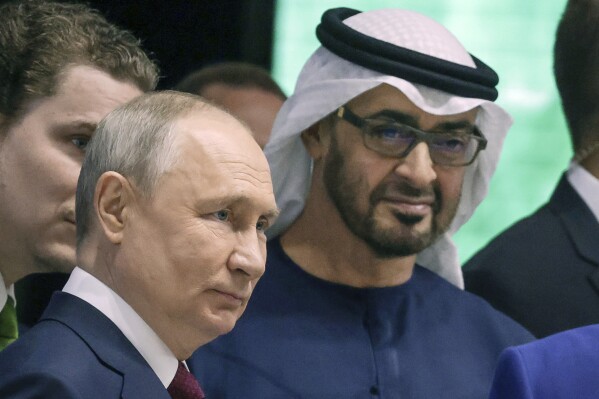 FILE - Russian President Vladimir Putin, left, and United Arab Emirates President Sheikh Mohamed bin Zayed Al-Nahyan visit an exhibition of the United Arab Emirates on the sideline of the St. Petersburg International Economic Forum in St. Petersburg, Russia, June 16, 2023. The United States on Thursday imposed a new round of sanctions on roughly 130 firms and people from Turkey to China to the United Arab Emirates in an effort to choke off Moscow's access to tools and equipment that support its invasion of Ukraine. (Vyacheslav Prokofyev, Sputnik, Kremlin Pool Photo via AP, File)