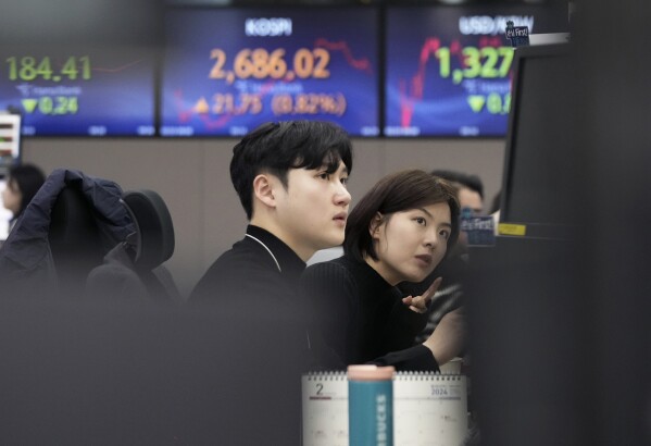 Currency traders watch monitors at the foreign exchange dealing room of the KEB Hana Bank headquarters in Seoul, South Korea, Friday, Feb. 23, 2024. Asian markets mostly gained on Friday after Nvidia delivered another blowout quarter, setting off a rally in other technology companies that carried Wall Street to another record high. (AP Photo/Ahn Young-joon)