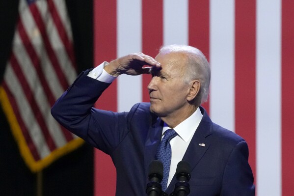 President Joe Biden pauses while speaking about democracy and the legacy of Arizona Republican Sen. John McCain to look up at supporters in the balcony at the Tempe Center for the Arts, Thursday, Sept. 28, 2023, in Tempe, Ariz. (AP Photo/Ross D. Franklin)