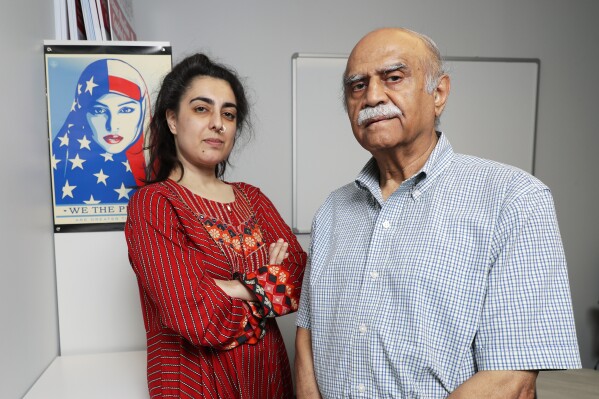 Palwasha Sharwani, executive director of Emgage Texas, left, and A.J. Durrani, right, a Harris County elections judge, pose for a photo on Wednesday, July 26, 2023, in Houston. (AP Photo/Michael Wyke)