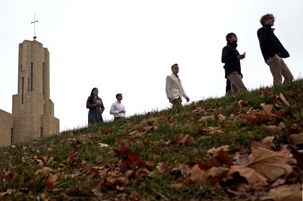 Students leave after attending a Catholic Mass at Benedictine College Sunday, Dec. 3, 2023, in Atchison, Kan. Many At a time when U.S. college enrollment is shrinking, the conservative Catholic school has expanded over the last 15 years. (AP Photo/Charlie Riedel)