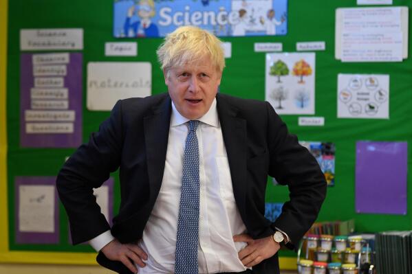 Britain's Prime Minister Boris Johnson visits the Field End Infant school, in South Ruislip, London, Friday May 6, 2022, following the local government elections. Britain’s governing Conservatives have suffered local election losses in their few London strongholds. Voting held Thursday for thousands of seats on more than 200 local councils decided who will oversee garbage collection and the filling of potholes, but were also seen as an important barometer of public opinion ahead of the next national election. (Daniel Leal/Pool via AP)