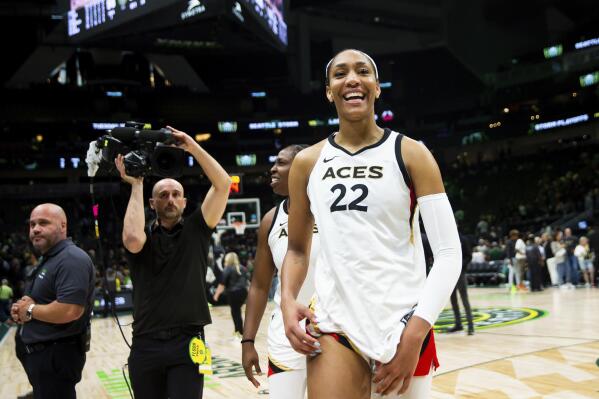 Las Vegas Aces forward A'ja Wilson (22) smiles while walking off the court after winning Game 3 of a WNBA basketball semifinal playoff series against the Seattle Storm, Sunday, Sept. 4, 2022, in Seattle. (AP Photo/Lindsey Wasson)