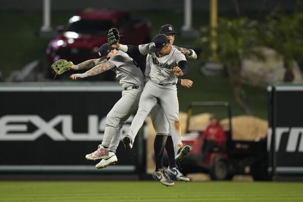 New York Yankees' Alex Verdugo, left, Juan Soto, center, and Aaron Judge celebrate after the Yankees defeated the Los Angeles Angels 2-1 in a baseball game Wednesday, May 29, 2024, in Anaheim, Calif. (AP Photo/Mark J. Terrill)