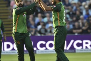 Pakistan's Haris Rauf, right, celebrates with Pakistan's Shadab Khan ager dismissing England's James Vince during the third one day international cricket match between England and Pakistan at Edgbaston cricket ground in Birmingham, England, Tuesday, July 13, 2021. (AP Photo/Rui Vieira)