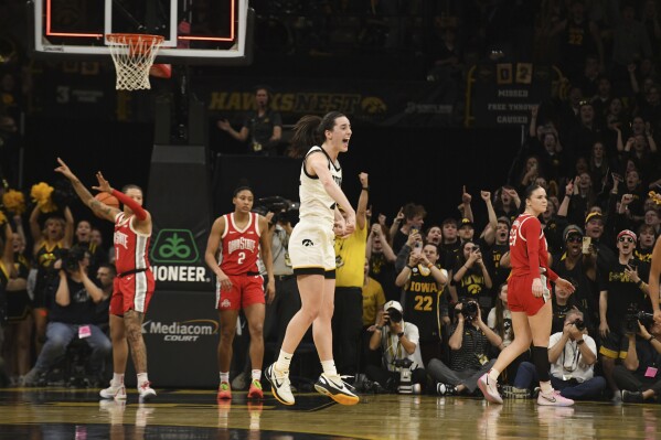 Iowa guard Caitlin Clark (22) celebrates after becoming the all-time leading scorer in NCAA Division I basketball during the first half of an NCAA college basketball game, Sunday, March 3, 2024, in Iowa City, Iowa. (AP Photo/Cliff Jette)