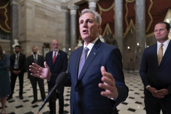 FILE - House Speaker Kevin McCarthy, R-Calif., joined by Rep. August Pfluger, R-Texas, right, and other GOP members, talks to reporters just after voting to advance appropriations bills on the House floor, at the Capitol in Washington, Tuesday night, Sept. 26, 2023. McCarthy is digging in on his refusal to take up Senate legislation designed to keep the federal government fully running beyond midnight Saturday, Sept. 30. (AP Photo/J. Scott Applewhite, File)