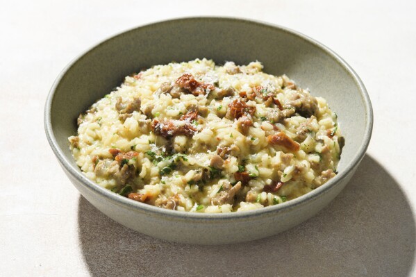 This image released by Milk Street shows a recipe for risotto with sausage and sun-dried tomatoes. (Milk Street via AP)