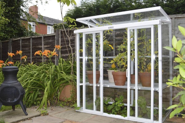 This image provided by Hartley Botanic shows a Patio model glasshouse with its hinged top pane open. (Hartley Botanic via AP)