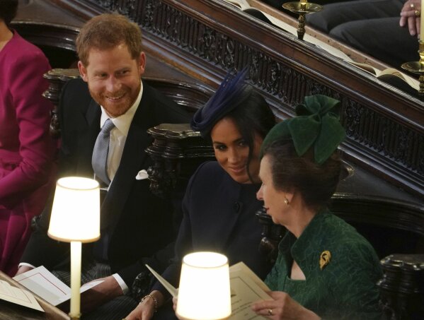 
              Britain's Prince Harry, Meghan, Duchess of Sussex and Britain's Princess Anne, from left, attend the wedding of Princess Eugenie of York and Jack Brooksbank in St George’s Chapel, Windsor Castle, near London, England, Friday Oct. 12, 2018. (Owen Humphreys, Pool via AP)
            