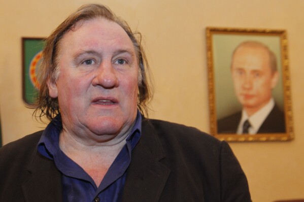French actor Gerard Depardieu smiles shortly visits museum of Akhmad Kadyrov, war lord, who switched side and became pro-Russian leader, in Chechnya's provincial capital Grozny, Russia, on Feb. 24, 2013. (AP Photo/Musa Sadulayev, File)