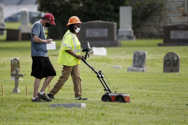 FILE - In this July 17, 2020, file photo, workers use ground penetrating radar to search for a potential unmarked mass grave from the 1921 Tulsa Race Massacre, at Oaklawn Cemetery in Tulsa, Okla. As the U.S. marks 100 years since one of its most shameful historical chapters, researchers, including descendants of Black victims of the Tulsa Race Massacre, are preparing to resume a search for remains believed to have been hastily buried in mass graves. (AP Photo/Sue Ogrocki File)
