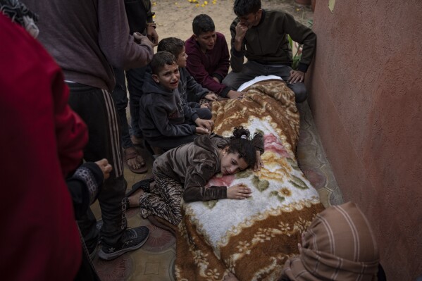Palestinians mourn their relatives killed in the Israeli bombardment of the Gaza Strip, in the hospital in Khan Younis, Saturday, Nov. 11, 2023. ( AP Photo/Fatima Shbair)