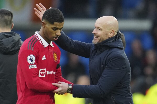 FILE - Manchester United's head coach Erik ten Hag congratulates with Marcus Rashford as he leaves the pitch during the English Premier League soccer match between Leeds United and Manchester United at Elland Road, Leeds, England, Sunday, Feb.12, 2023. Marcus Rashford has committed himself to five more years at Manchester United after the most prolific season of his career. The England forward ended speculation about his future by signing a new long-term deal that will keep him at Old Trafford through to 2028. (AP Photo/Jon Super, File)