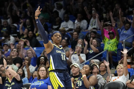 Dallas Wings guard Arike Ogunbowale celebrates after sinking a 3-point basket during the first half of the team's WNBA basketball game against the Washington Mystics, Friday, July 28, 2023, in Arlington, Texas. (AP Photo/Tony Gutierrez)