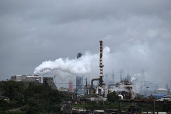 FILE - Steam emits from a crude oil refinery in Kochi, Kerala state, India, Aug. 26, 2022. The United Nations will require delegates attending its annual climate summit to disclose their affiliation in an effort to clamp down on undue influence by fossil fuel companies and others. (AP Photo/R S Iyer, File)