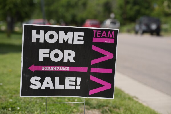 A for sale sign stands outside a single-family residence on Sunday, June 18, 2023, in Denver. The National Association of Realtors on Thursday releases June data for sales of existing homes. (AP Photo/David Zalubowski)