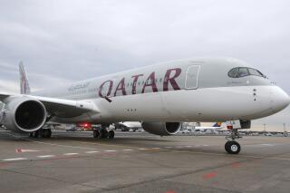 FILE - In this Jan. 15, 2015 file photo, a new Qatar Airways Airbus A350 approaches the gate at the airport in Frankfurt, Germany. Qatar Airways said Thursday, Aug. 5, 2021, that it has grounded 13 Airbus A350s over degradation of the plane's fuselage, further escalating a monthslong dispute with the European airplane maker. (AP Photo/Michael Probst, File)