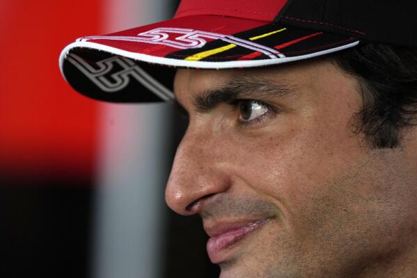 Ferrari driver Carlos Sainz of Spain speaks as he arrives in the paddock at the Dino and Enzo Ferrari racetrack, in Imola, Italy, Thursday, April 21, 2022. Italy's Emila Romagna Formula One Grand Prix will take place on Sunday. (AP Photo/Luca Bruno)