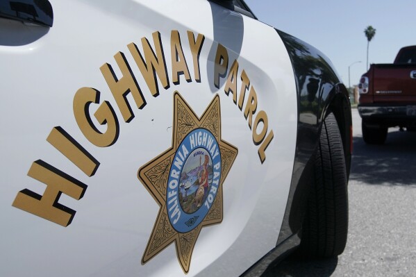 FILE - A California Highway Patrol officer stops a motorist in Anaheim, Calif., April 23, 2020. State authorities were investigating Monday, Nov. 20, 2023, after a California Highway Patrol officer shot and killed a man on a Los Angeles area freeway during a struggle over the weekend that was recorded on video. (AP Photo/Chris Carlson, File)