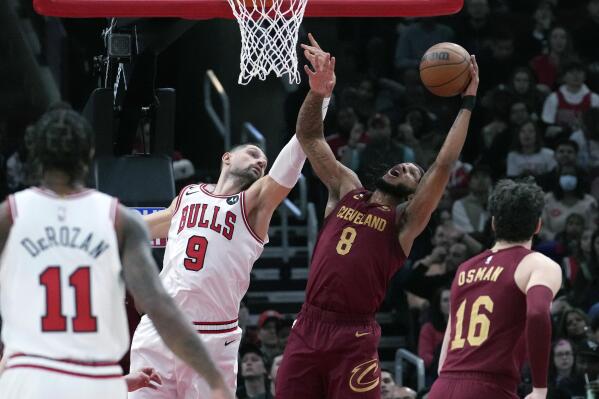 Cleveland Cavaliers forward Lamar Stevens (8) rebounds the ball against Chicago Bulls center Nikola Vucevic during the first half of an NBA basketball game in Chicago, Saturday, Dec. 31, 2022. (AP Photo/Nam Y. Huh)