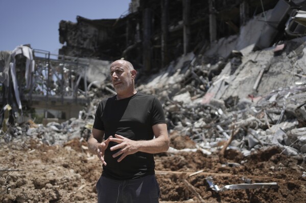 Professor Roee Ozeri speaks in front of damage to the Weizmann Institute of Science from an Iranian missile strike in Rehovot, Thursday, June 19, 2025. (AP Photo/Maya Alleruzzo)