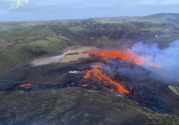 This image provided by the Icelandic Coast Guard shows a volcano on the Reykjanes Peninsula in southwestern Iceland on Saturday March 20, 2021. A long dormant volcano on the Reykjanes Peninsula flared to life Friday night, spilling lava down two sides in that area's first volcanic eruption in nearly 800 years. Initial aerial footage, posted on the Facebook page of the Icelandic Meteorological Office, showed a relatively small eruption so far, with two streams of lava running in opposite directions. (Icelandic Coast Guard via AP)