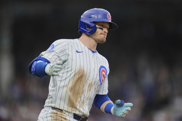 Chicago Cubs' Ian Happ runs the bases after hitting a grand slam during the seventh inning of a baseball game against the Arizona Diamondbacks, Friday, April 18, 2025, in Chicago. (AP Photo/Erin Hooley)