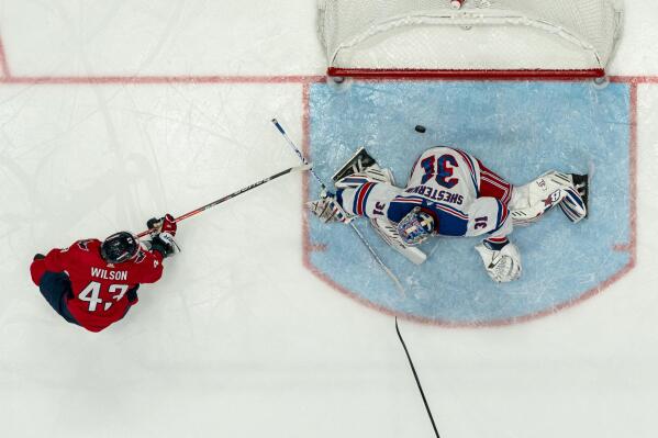 A shot by Washington Capitals right wing Tom Wilson (43) gets by New York Rangers goaltender Igor Shesterkin (31) for a goal during the second period of an NHL hockey game, Saturday, Feb. 25, 2023, in Washington. The Capitals won 6-3. (AP Photo/Julio Cortez)
