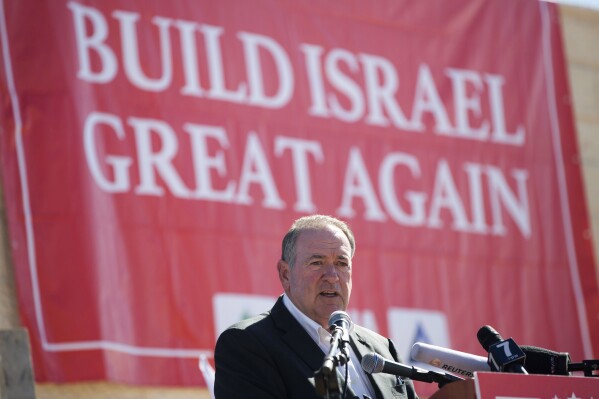 FILE - Gov. Mike Huckabee, R-Ark., takes questions from the media, prior to laying a brick at a new housing complex in the West Bank settlement of Efrat, Aug. 1, 2018. President-elect Donald Trump will nominate former Arkansas Gov. Mike Huckabee as ambassador to Israel. Trump said Tuesday that Huckabee is a staunch defender of Israel and his intended nomination comes as Trump has promised to align U.S. foreign policy more closely with Israel’s interests as it wages wars against Hamas in Gaza and Hezbollah in Lebanon.(AP Photo/Oded Balilty, File)