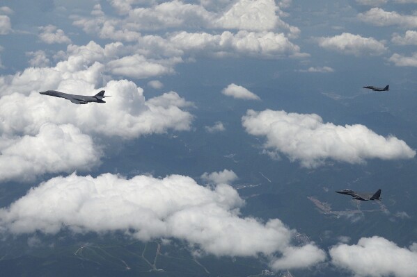 In this photo provided by the South Korea Defense Ministry, U.S. Air Force B-1B bomber, left, and South Korean fighter jets F-15K fly over the Korean Peninsula during the joint aerial drills between South Korea and the United States, South Korea, Wednesday, June 5, 2024. (South Korea Defense Ministry via AP)