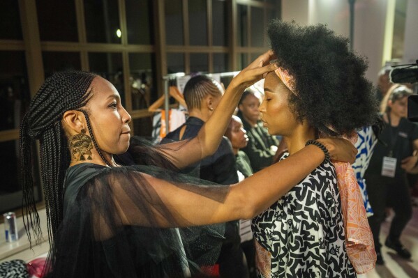 Niger fashion designer Alia Bare prepares a model for her show during Johannesburg Fashion Week 2023 in Johannesburg, South Africa, Thursday, Nov. 9, 2023. (AP Photo/Jerome Delay)