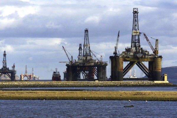 FILE - North sea oil exploration platforms lie in the Cromerty Firth in northern Scotland on March 2, 2003. British regulators on Wednesday, Sept. 27, 2023, approved new oil and gas drilling in the North Sea, a move environmentalists say will hurt the country’s attempt to meet its climate goals. (AP Photo/Martin Cleaver)