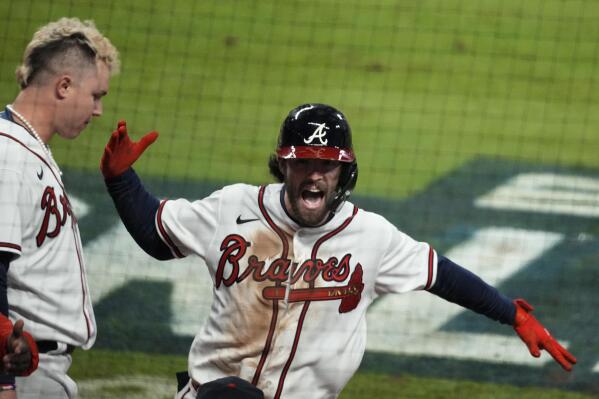 Atlanta Braves' Dansby Swanson celebrates a home run during the seventh inning in Game 4 of baseball's World Series between the Houston Astros and the Atlanta Braves Saturday, Oct. 30, 2021, in Atlanta. (AP Photo/Brynn Anderson)