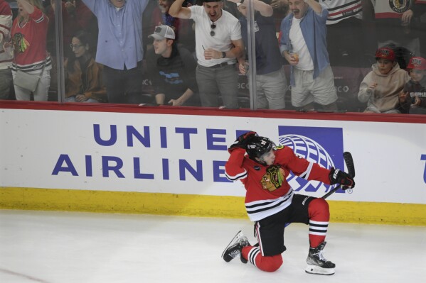 Chicago Blackhawks' Frank Nazar celebrates after scoring his first goal in the NHL during the first period of a NHL hockey game against the Carolina Hurricanes, Sunday, April 14, 2024, in Chicago. (AP Photo/Paul Beaty)