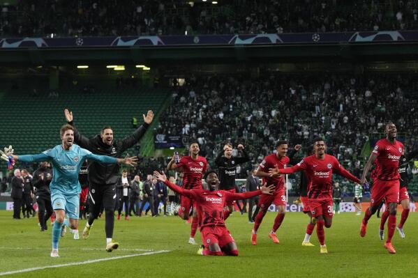 Frankfurt players celebrate after beating Sporting to quality for the next round after a Champions League group D soccer match between Sporting CP and Frankfurt at the Alvalade stadium in Lisbon, Tuesday, Nov. 1, 2022. (AP Photo/Armando Franca)
