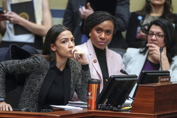 FILE - In this Feb. 26, 2019, file photo, Rep. Alexandria Ocasio-Cortez, D-N.Y., left, joined by Rep. Ayanna Pressley, D-Mass., and Rep. Rashida Tlaib, D-Mich., listens during a House Oversight and Reform Committee meeting on Capitol Hill in Washington. In tweets Sunday, July 14, 2019, President Donald Trump portrays the lawmakers as foreign-born troublemakers who should go back to their home countries. In fact, the lawmakers, except one, were born in the U.S. He didn’t identify the women but was referring to Reps. Ocasio-Cortez, Pressley, Tlaib and Ilhan Omar. (AP Photo/J. Scott Applewhite, File)